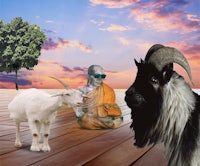 a goat is standing next to a buddhist monk