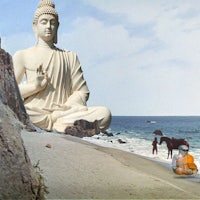 a buddha statue on a beach