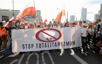 a group of people holding a banner that says stop totalitarian yugoslavia