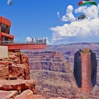 a woman is standing on the edge of a cliff overlooking the grand canyon