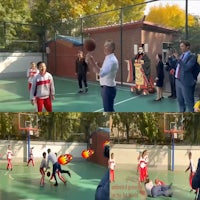 a group of people playing basketball in a court