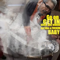 a man is sitting in front of a statue with the words go on get you going and not like a fucking baby